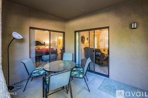 A living room with a glass table and chairs.