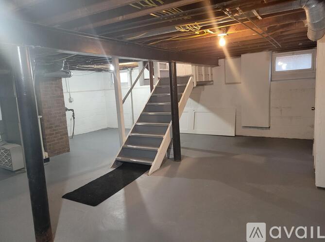 A large open space with a staircase leading to the upper level.