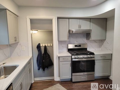 A kitchen with a stove top oven and a sink.