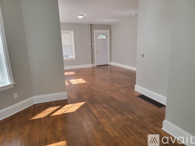 A room with wooden floors and a white door.