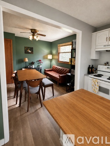 A kitchen with a table and chairs in the middle of the room.