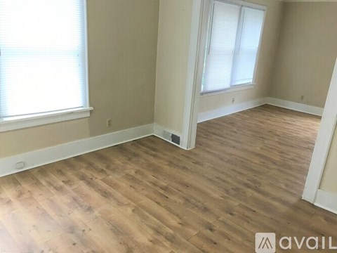 A room with wooden flooring and a window.