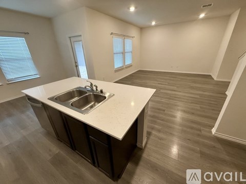 A kitchen with a sink and a countertop is available for rent.