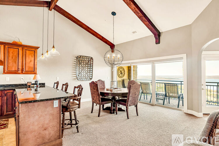 A kitchen with a dining table and chairs is shown.