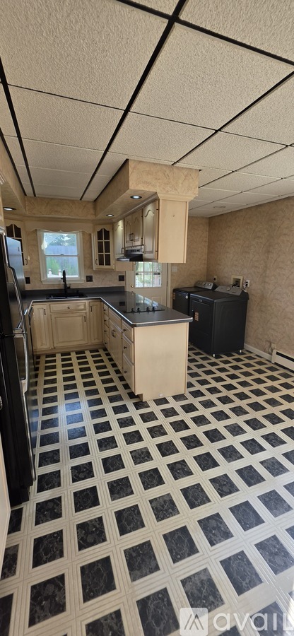 A kitchen with black and white checkered floor.
