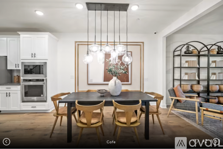 A modern dining room with a black table and chairs.