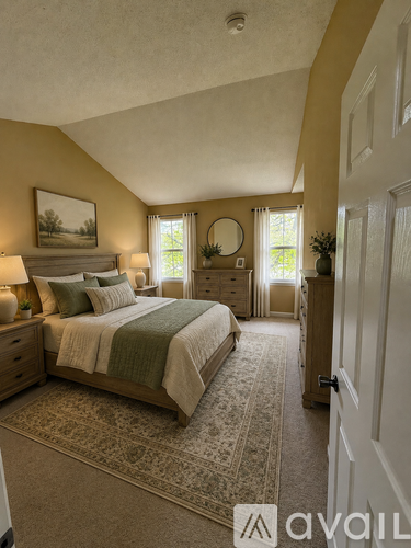 A bedroom with a large bed and a painting on the wall.