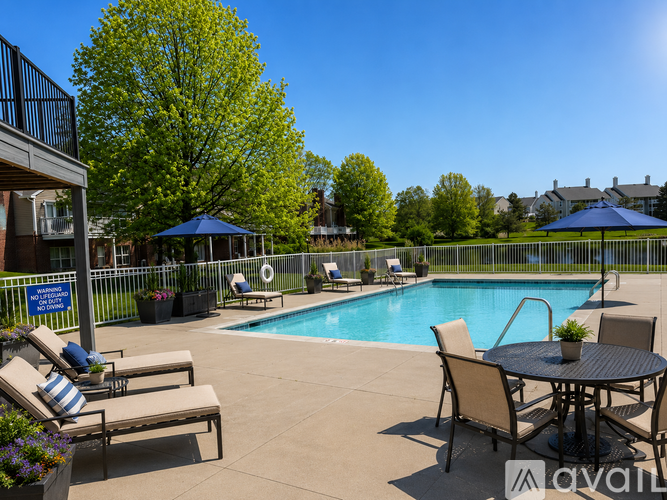 A pool area with chairs and a table.