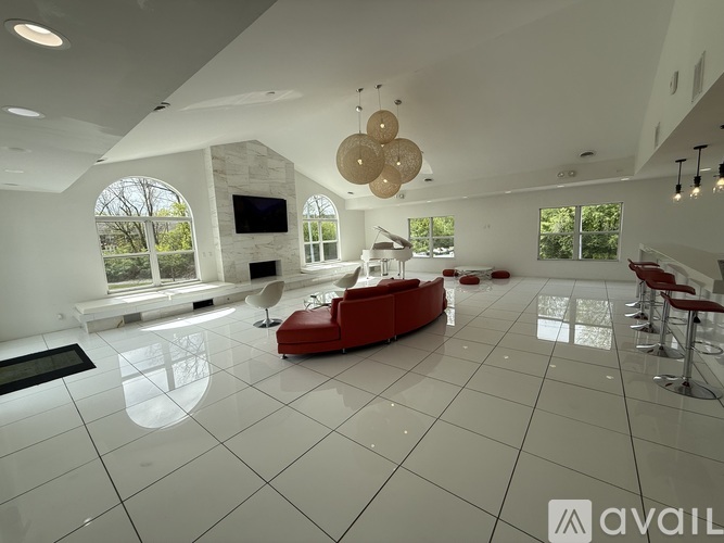A spacious living room with a red sofa and a television.
