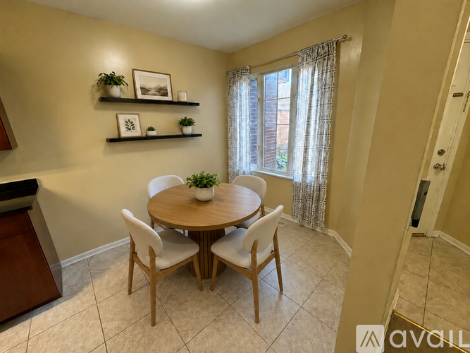 A dining room with a round table and chairs.