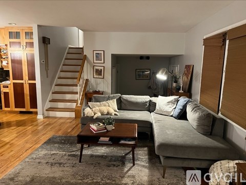 A living room with a grey couch and a coffee table.