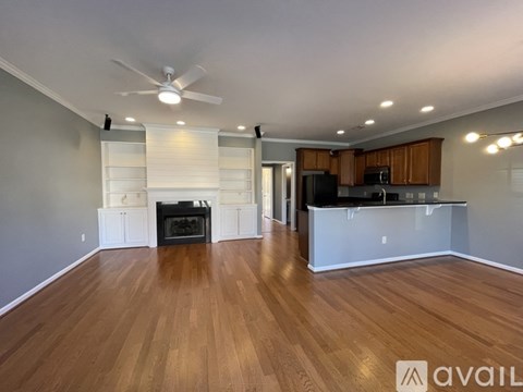 A spacious living room with a television and a bar area.