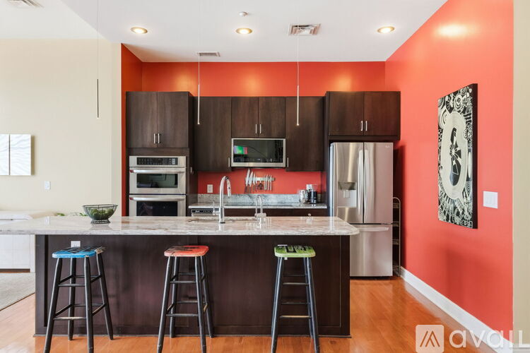 A kitchen with brown cabinets and a stainless steel oven.