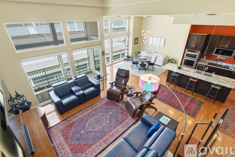 A spacious room with wooden floors and a ceiling fan.