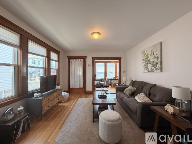 A living room with a grey couch and a television.