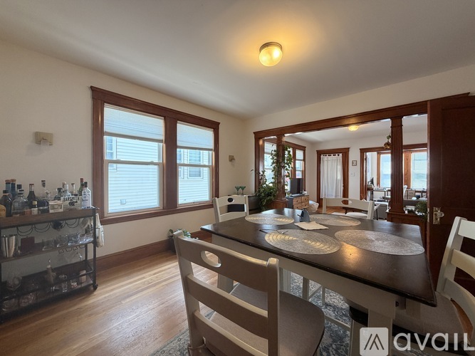 A kitchen with a dining table and chairs.