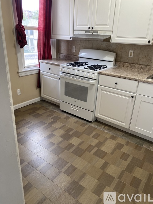 A kitchen with a white stove and oven.