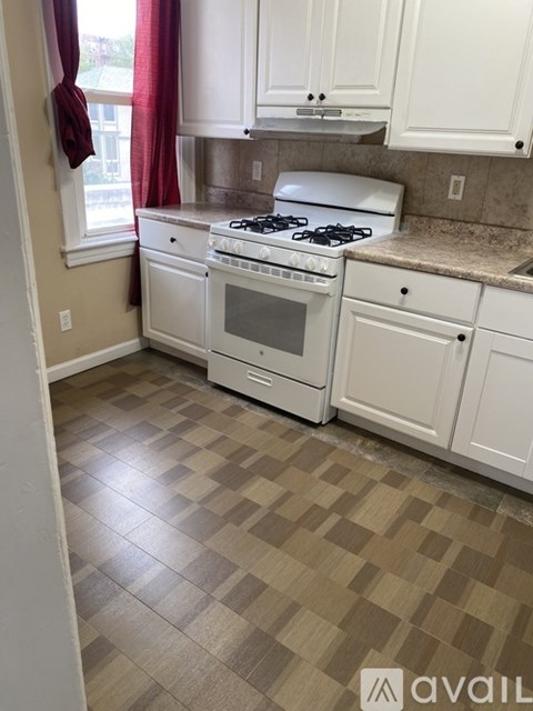 A kitchen with a white stove and oven.