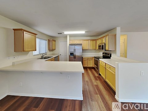 A kitchen with wooden cabinets and a white island.
