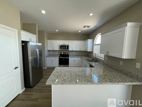 A kitchen with granite countertops and stainless steel appliances.