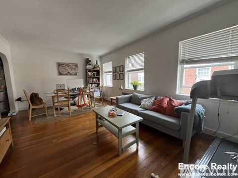 A living room with a grey couch and a coffee table.
