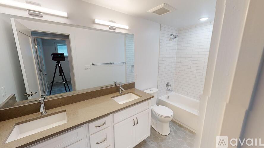 A bathroom with a sink, toilet, and bathtub.