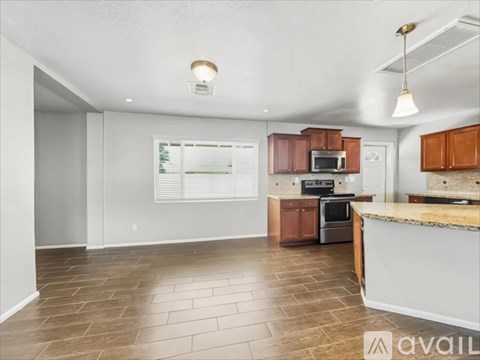 A kitchen with brown cabinets and a white countertop.