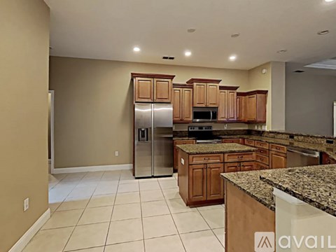 A kitchen with wooden cabinets and granite countertops.
