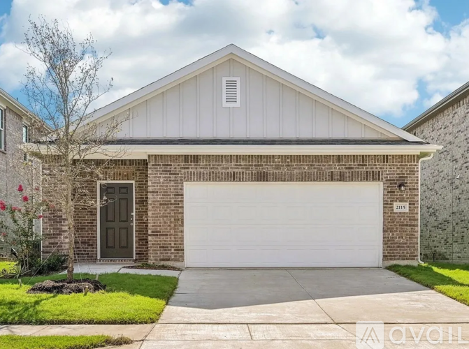 A house with a garage door and a brown door.