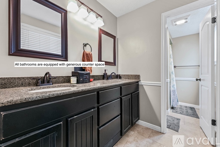 A bathroom with a sink, mirror, and a large counter space.
