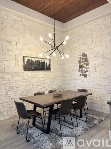 A dining room with a wooden table and chairs.