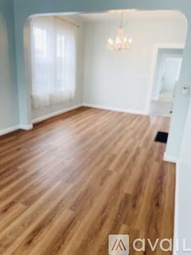 A kitchen with white cabinets and a tiled floor.