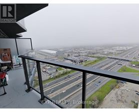 A view from a balcony overlooking a busy highway.