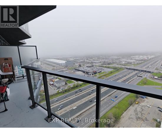 A view from a balcony overlooking a busy highway.
