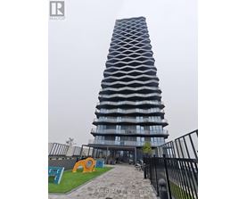A tall building with a unique design is shown in the image.