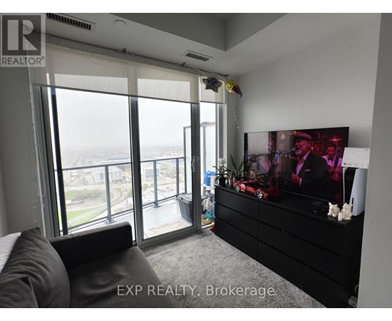 A living room with a large couch and a flat screen TV.