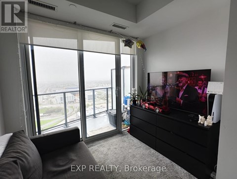 A living room with a large couch and a flat screen TV.