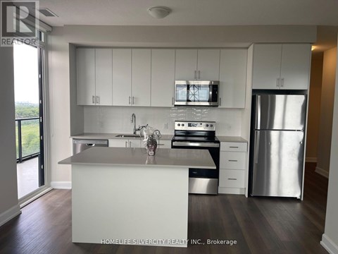 A modern kitchen with white cabinets and stainless steel appliances.