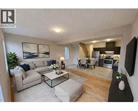 A living room with a couch, a coffee table, and a television.