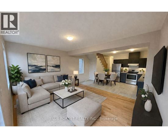 A living room with a couch, a coffee table, and a television.
