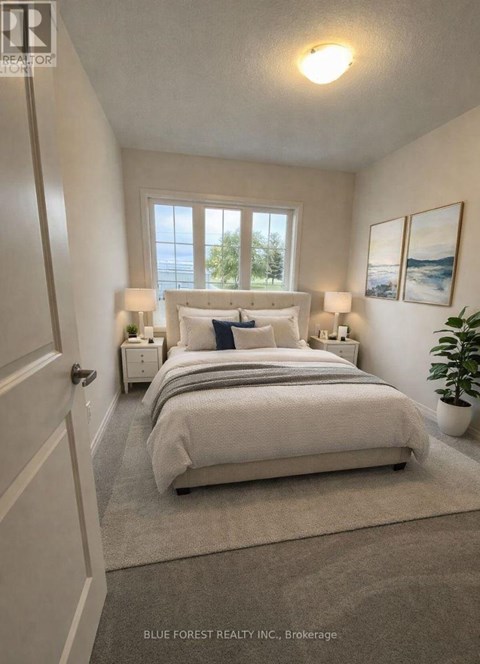 A bedroom with a large bed and two lamps.
