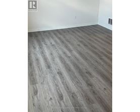 A room with a wooden floor and white walls.