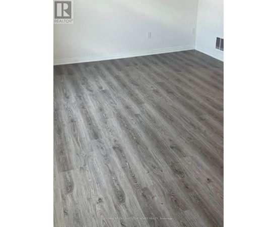 A room with a wooden floor and white walls.