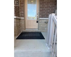 A door with a glass window and a black mat in front of it.