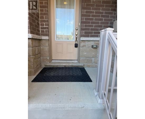 A door with a glass window and a black mat in front of it.
