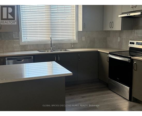 A kitchen with a stainless steel oven and sink.