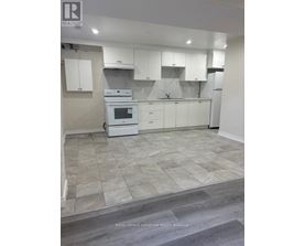 A kitchen with white appliances and cabinets.