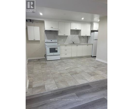 A kitchen with white appliances and cabinets.