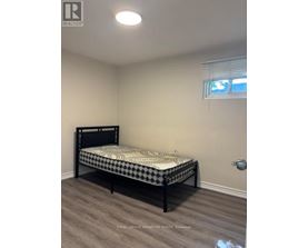 A bedroom with a bed and a window.