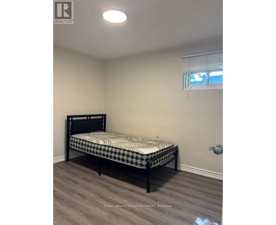 A bedroom with a bed and a window.
